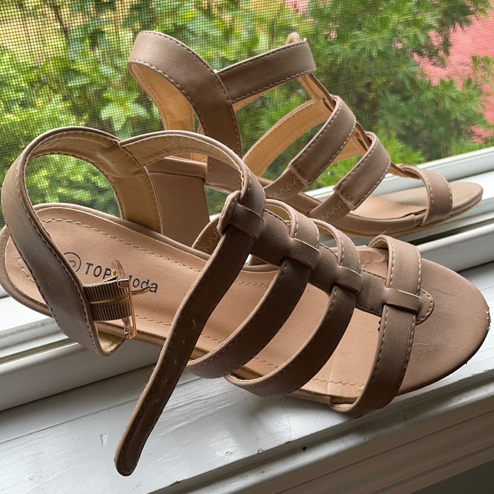 Tan sandals with a small heel.